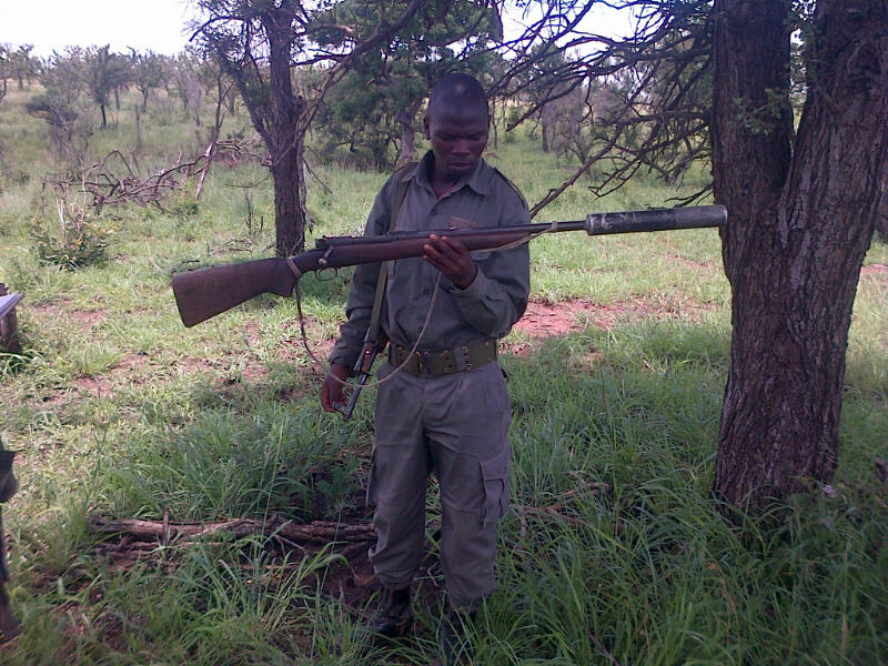 Ranger examines rifle serial number near Kruger-Mozambique border